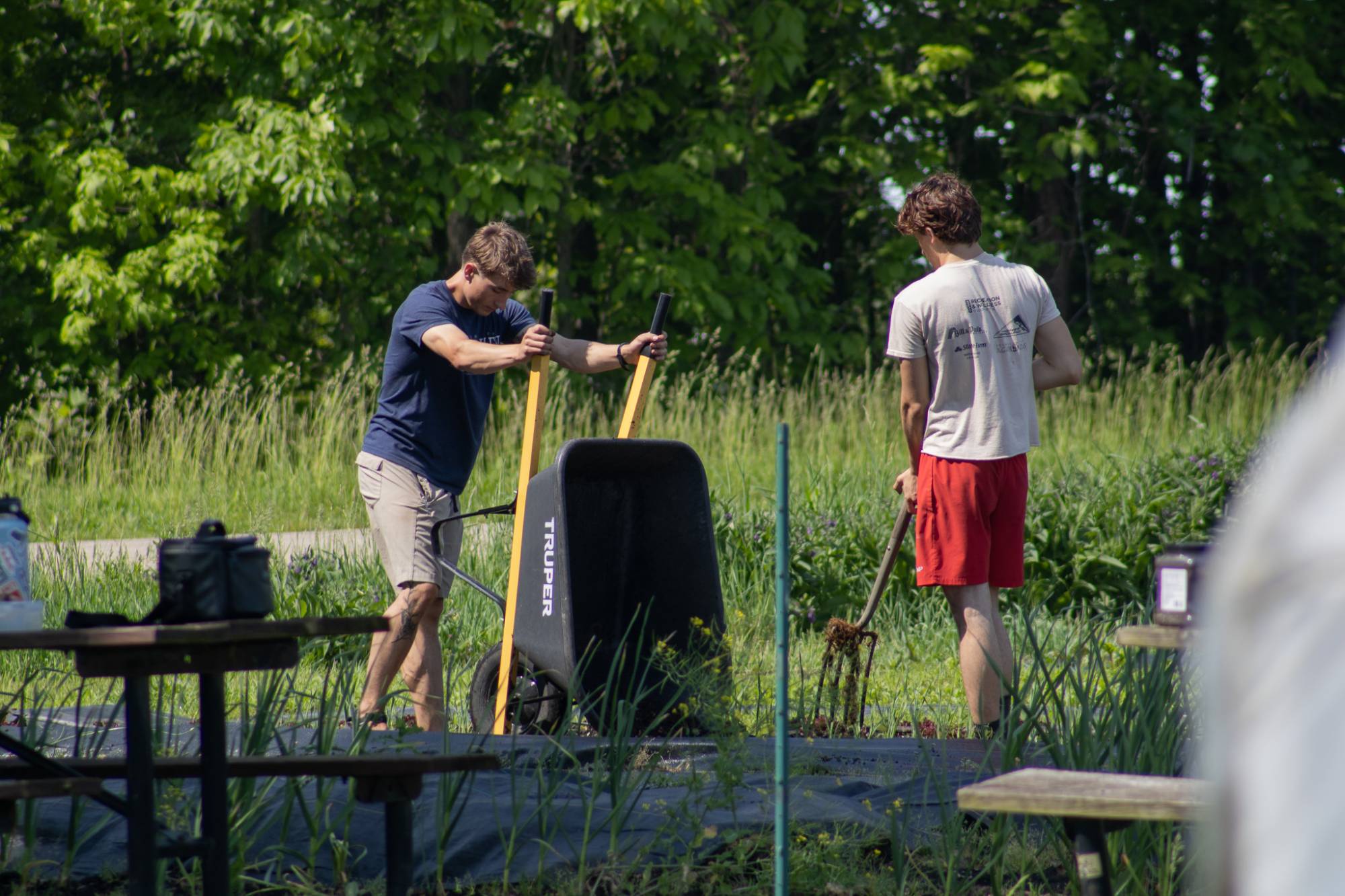 Farm crew members adding woodchips to the south field.